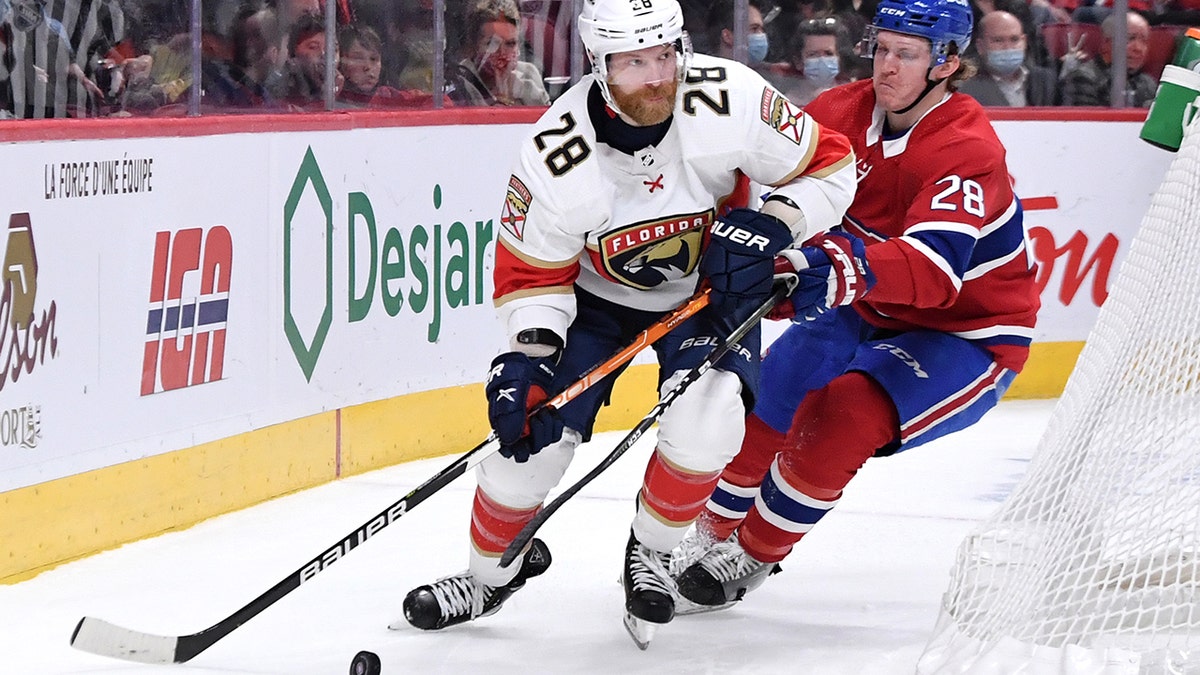 Claude Giroux #28 of the Florida Panthers looks to pass the puck against Christian Dvorak #28 of the Montreal Canadiens in the NHL game at the Bell Centre on March 24, 2022 in Montreal, Quebec, Canada.