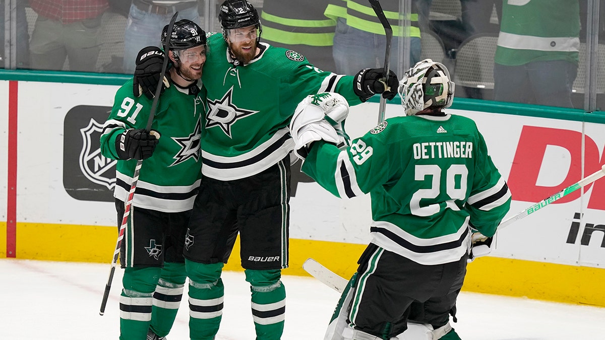 Dallas Stars center Tyler Seguin (91) celebrates his empty-net goal with Jani Hakanpaa (2) and goaltender Jake Oettinger (29) during the third period of the team's NHL hockey game against the Edmonton Oilers in Dallas, Tuesday, March 22, 2022. The Stars won 5-3.