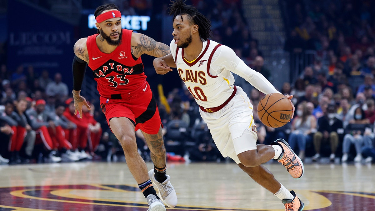 Cleveland Cavaliers' Darius Garland (10) drives against Toronto Raptors' Gary Trent Jr. (33) during the first half of an NBA basketball game, Sunday, March 6, 2022, in Cleveland.