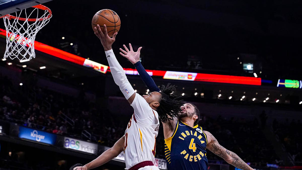 Cleveland Cavaliers guard Darius Garland (10) shoots in front of Indiana Pacers guard Duane Washington Jr. (4) during the first half of an NBA basketball game in Indianapolis, Tuesday, March 8, 2022. The Cavaliers won 127-124.