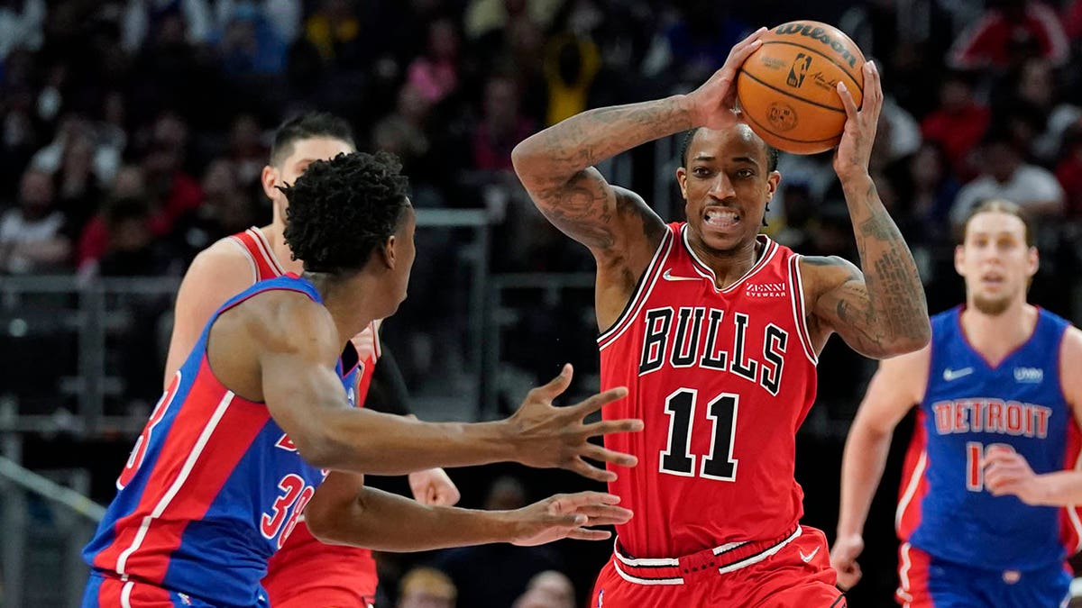 Chicago Bulls forward DeMar DeRozan (11) looks to pass as Detroit Pistons guard Saben Lee (38) defends during the second half of an NBA basketball game, Wednesday, March 9, 2022, in Detroit.