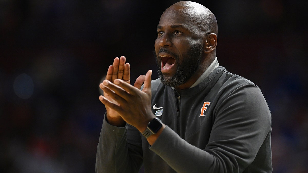 Head coach Dedrique Taylor of the Cal State Fullerton Titans cheers on his team against the Duke Blue Devils during the first round of the 2022 NCAA Men's Basketball Tournament held at Bon Secours Wellness Arena on March 18, 2022 in Greenville, South Carolina.