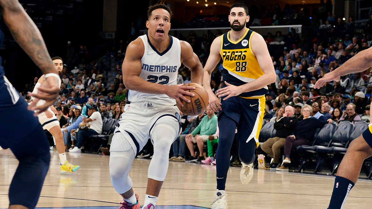 Memphis Grizzlies guard Desmond Bane (22) drives ahead of Indiana Pacers center Goga Bitadze (88) in the second half of an NBA basketball game Thursday, March 24, 2022, in Memphis, Tenn.
