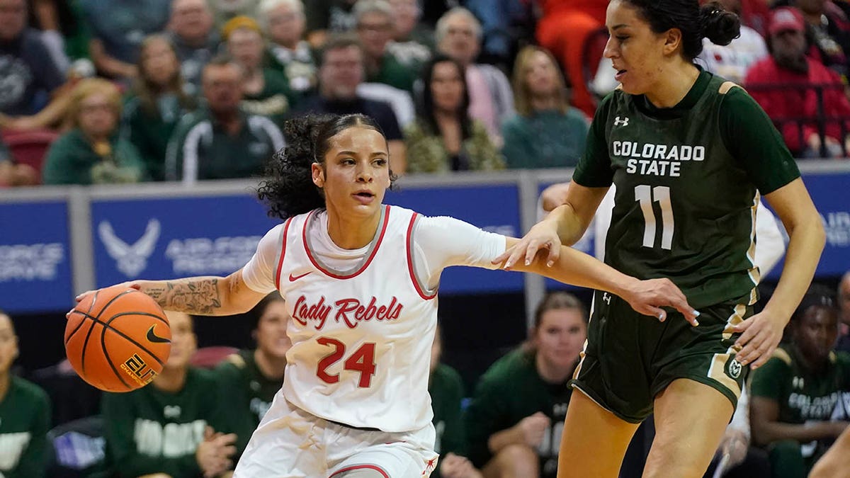 UNLV guard Essence Booker (24) drives as Colorado State guard Petra Farkas (11) defends during the first half of an NCAA college basketball game for the championship of the Mountain West Conference women's tournament Wednesday, March 9, 2022, in Las Vegas.