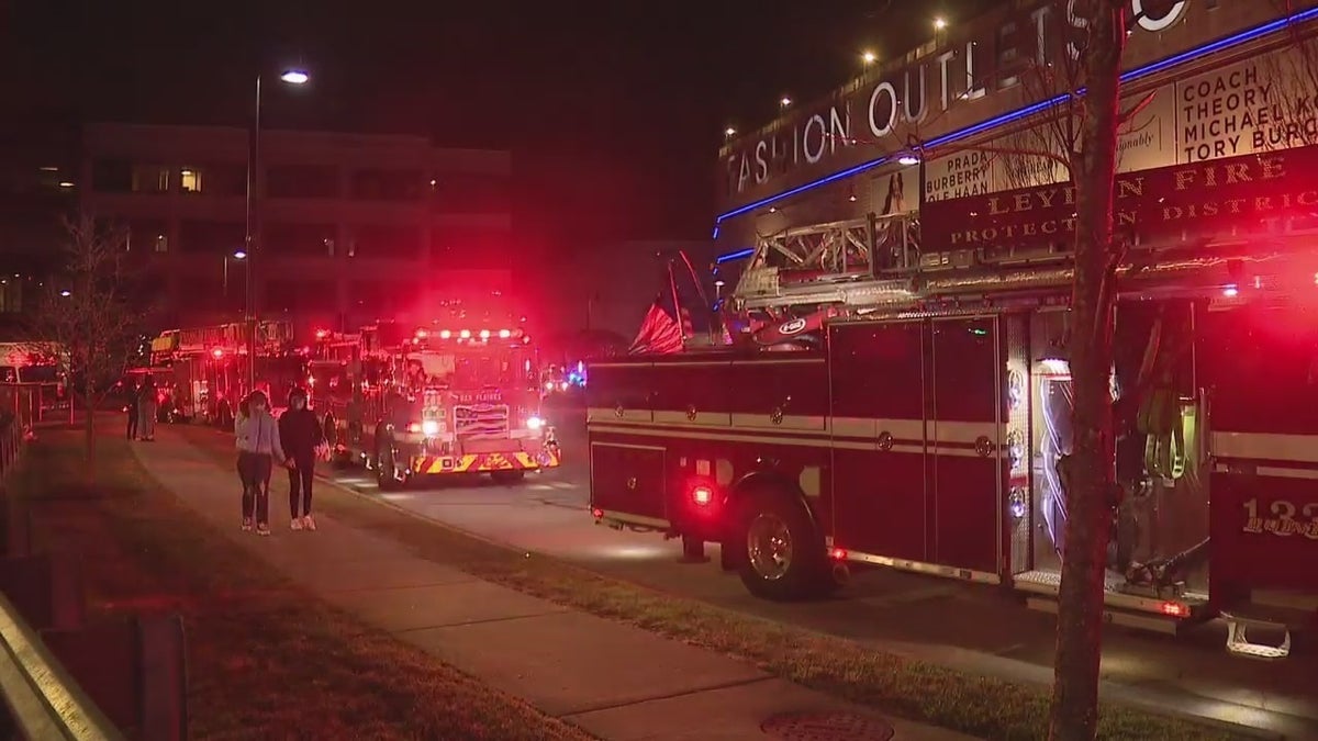 Fire trucks gathered outside the Fashion Outlets of Chicago shopping mall in Rosemont, Illinois Friday night. Two people were shot inside the outlet mall, police said. 