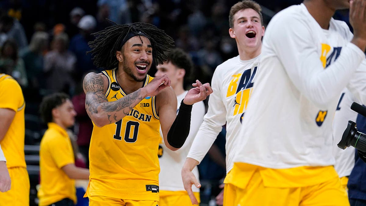 Michigan guard Frankie Collins (10) celebrates with teammates at the end of a college basketball game against Colorado State in the first round of the NCAA tournament in Indianapolis, Thursday, March 17, 2022. Michigan won 75-63.