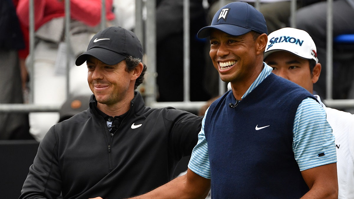 Tiger Woods of the U.S. (right) shakes hands with Rory McIlroy of Northern Ireland at the first hole tee at a "Japan Skins" pre-match ahead of the ZOZO Championship golf tournament at the Narashino Country Club in Inzai, Chiba prefecture Oct. 21, 2019.