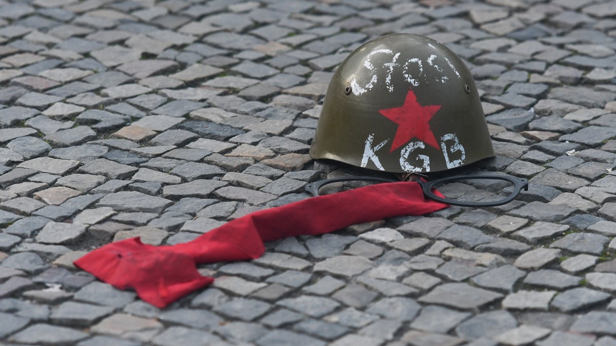 A Russian KGB/Stasi helmet in front of Brandenburg Gate in Berlin