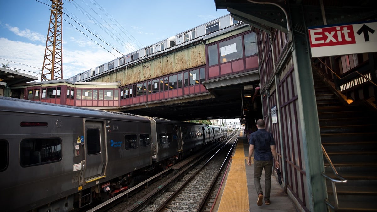 A commuter walks on the platform of the Woodside LIRR train station in the Queens borough of New York on Monday, Aug. 3, 2020. 
