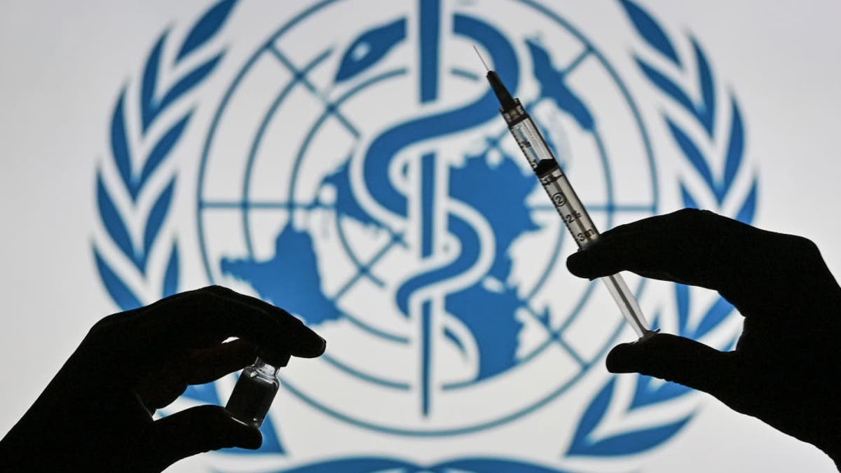 Black hand sillhouettes holding syringe with WHO logo behind it