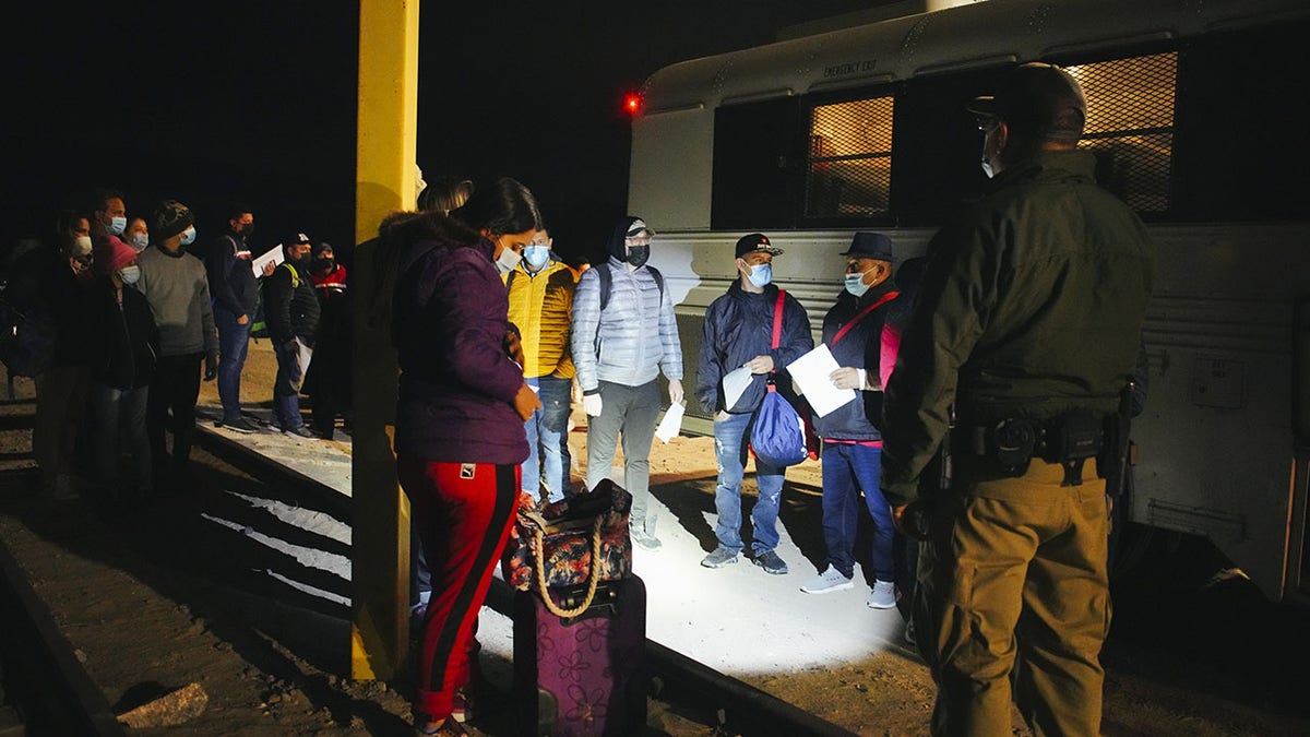 Feb 23 2022: Asylum seekers from Guatemala, Cuba, and Colombia board a bus to a USA immigration facility in the early morning hours in Yuma, Arizona, United States on February 22, 2022. ?(Photo by Katie McTiernan/Anadolu Agency via Getty Images)