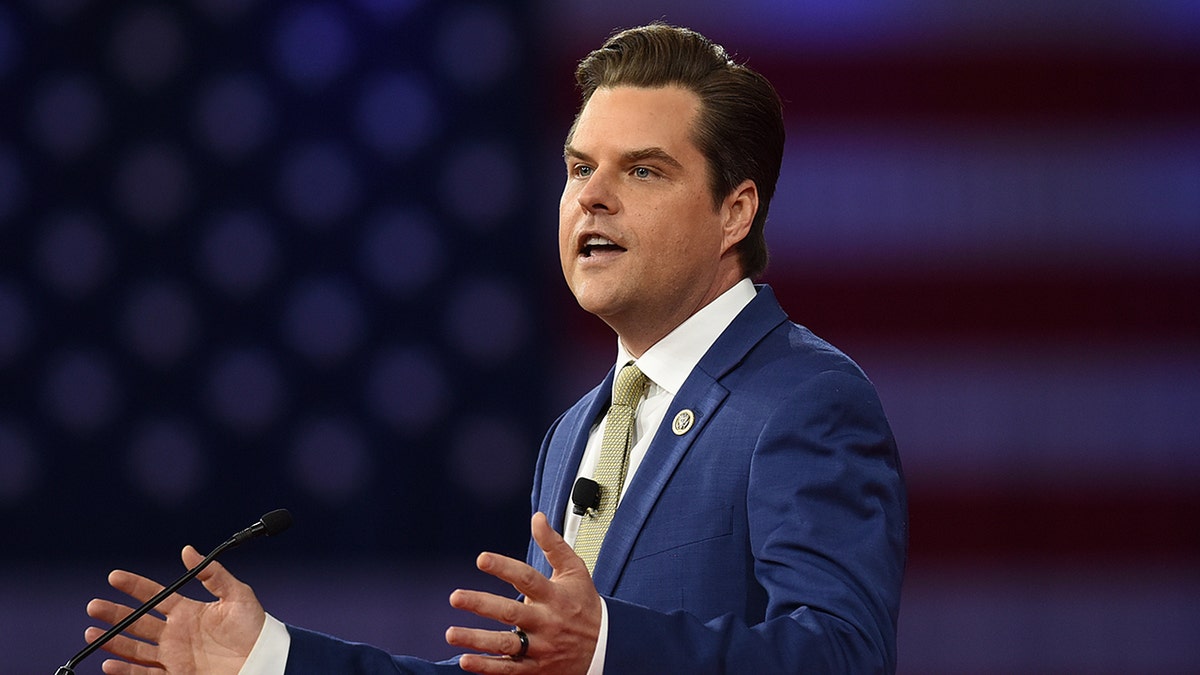 Matt Gaetz speaking with an American flag behind him