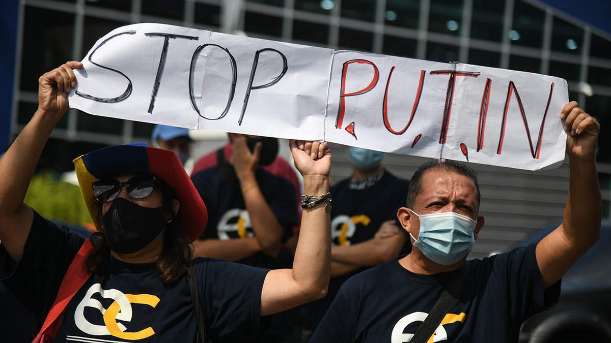 Demonstrators hold a "Stop Putin" banner during a protest against Russia's invasion of Ukraine outside the European Union consulate in Caracas, Venezuela, on Thursday, March 3, 2022. 