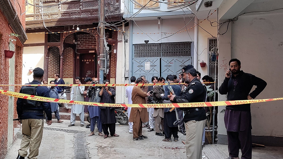 Policemen cordon off a street leading to a mosque after a bomb blast in Peshawar on March 4, 2022.