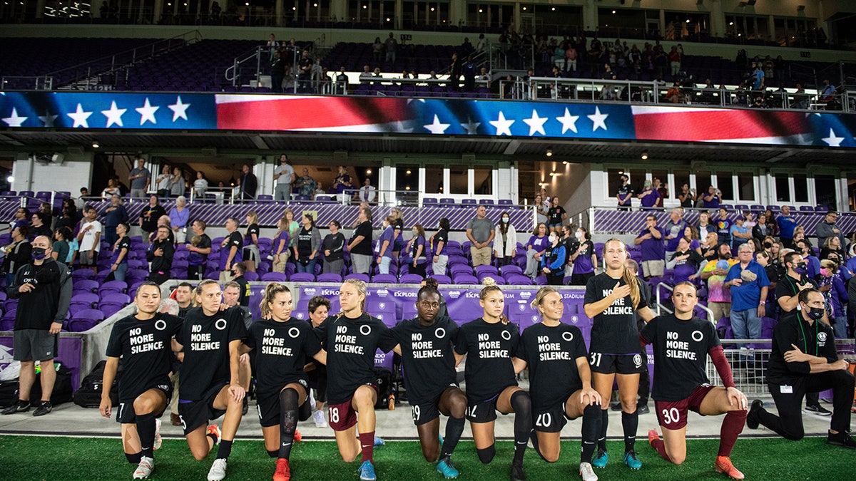 Orlando Pride players kneeling for the anthem before a game between Chicago Red Stars and Orlando Pride at Exploria Stadium on October 29, 2021, in Orlando, Florida.