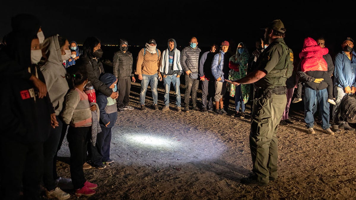 Border Patrol agents and migrants