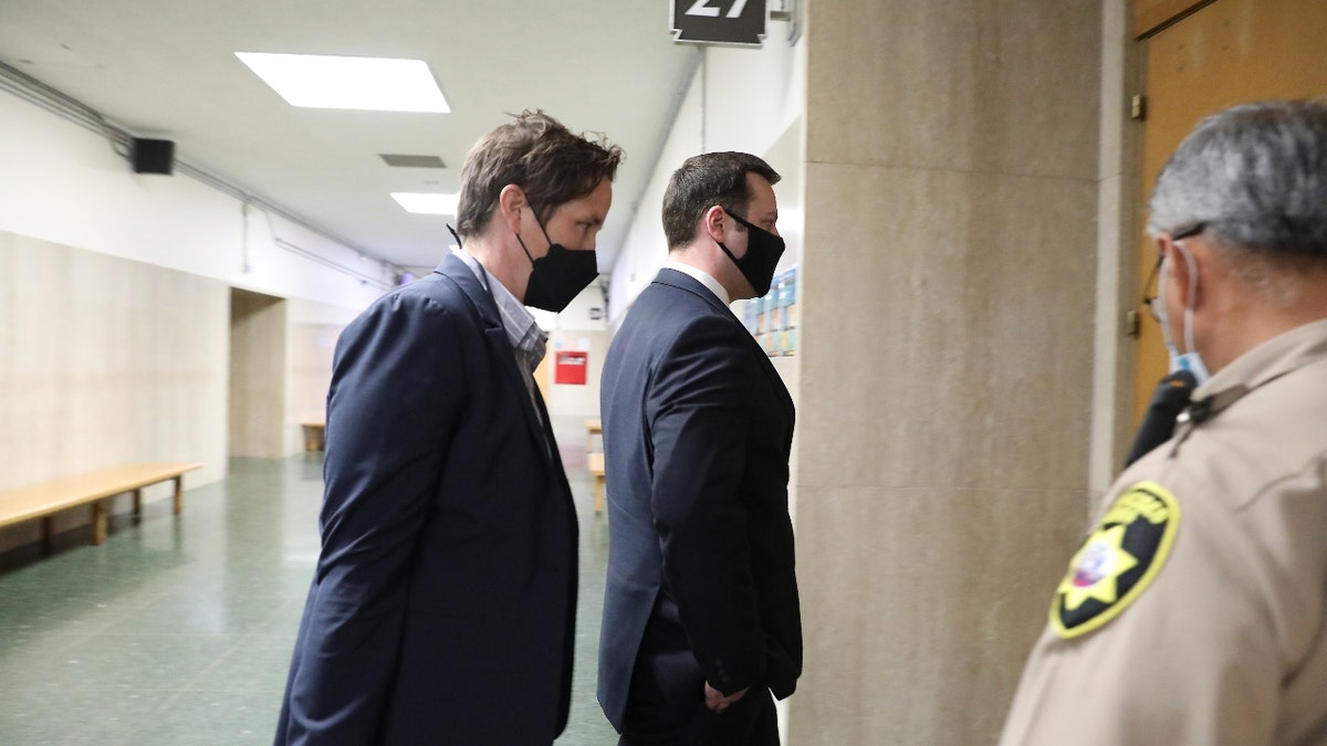 San Francisco Police officer Terrance Stangel (second from the left) enters Department 27 at the Hall of Justice with his attorney Nicole Pifari (left) on Monday, March 7, 2022 in San Francisco, Calif. (Lea Suzuki/San Francisco Chronicle via Getty Images)