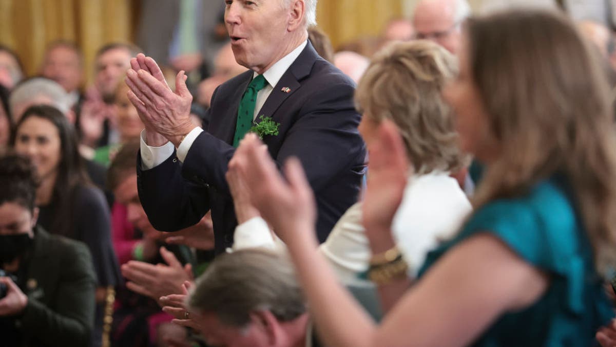 President Joe Biden applauds for entertainers who performed during an event celebrating St. Patrick’s Day in the East Room of the White House March 17, 2022, in Washington, D.C. (Photo by Win McNamee/Getty Images)