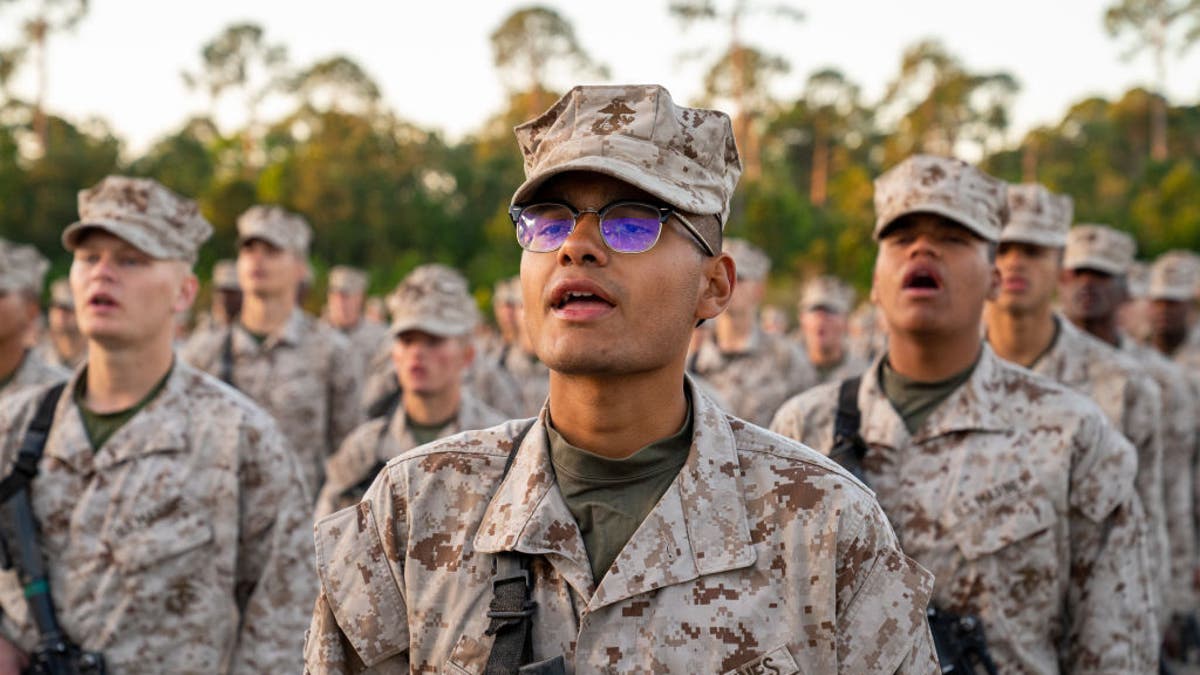 US Marine Corps recruits take part in the traditional Eagle, Globe and Anchor medal ceremony. (Photo by Robert Nickelsberg/Getty Images)