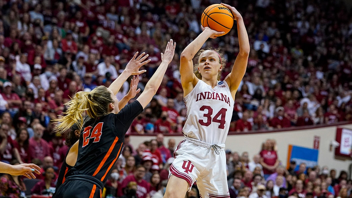 Indiana guard Grace Berger (34) shoots over Princeton guard Julia Cunningham (24) in the second half of a college basketball game in the second round of the NCAA tournament in Bloomington, Ind., Monday, March 21, 2022. Indiana defeated Princeton 56-55.