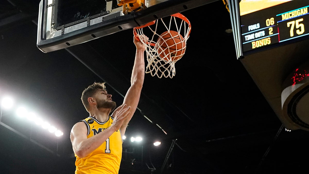 Michigan center Hunter Dickinson (1) dunks during the second half of an NCAA college basketball game against Michigan State, Tuesday, March 1, 2022, in Ann Arbor, Mich. 