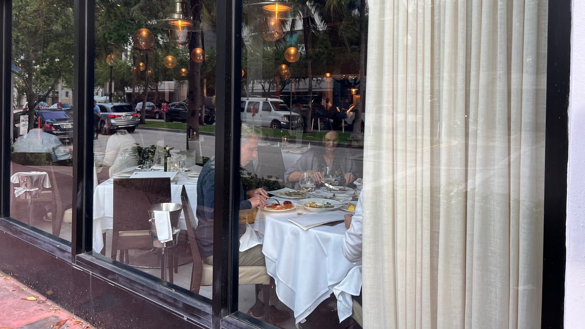 Diners enjoy a meal at Papi Steak on First Street in Miami Beach Friday, March 25.
