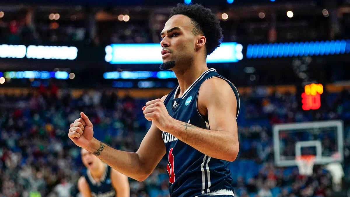 Richmond's Jacob Gilyard (0) celebrates after teammate Nathan Cayo scored in the second half of a college basketball game against the Iowa during the first round of the NCAA men's tournament, Thursday, March 17, 2022, in Buffalo, N.Y.