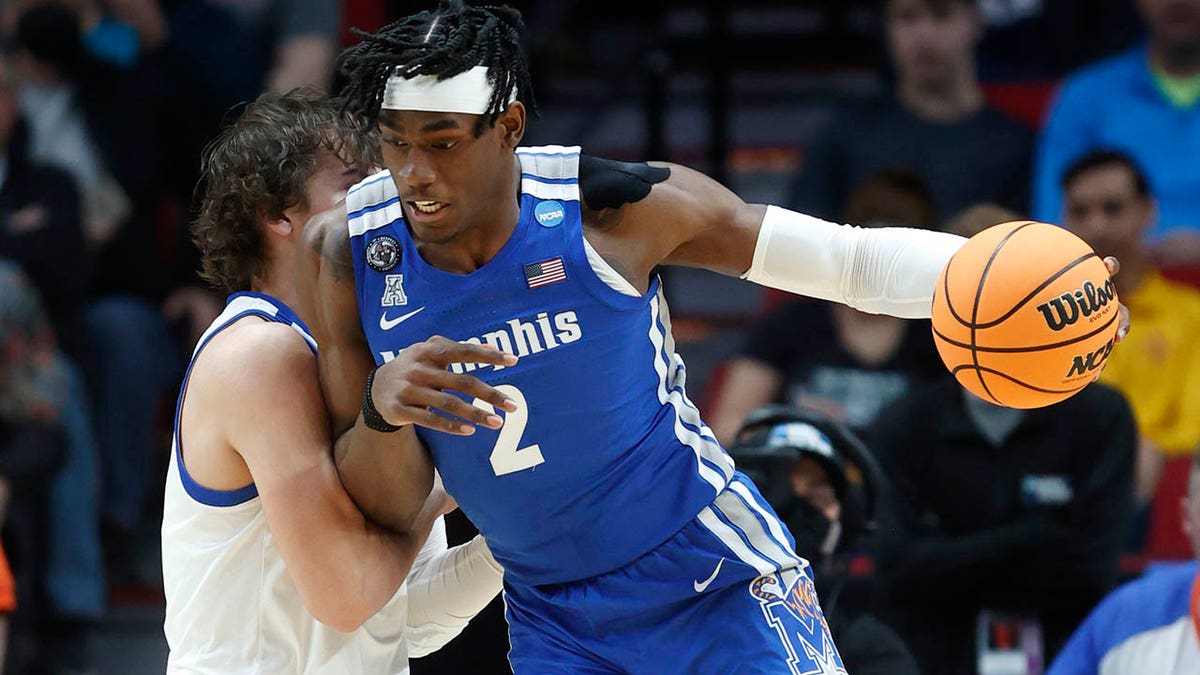 Memphis center Jalen Duren (2) drives past Boise State forward Tyson Degenhart, left, during the first half of a first round NCAA college basketball tournament game, Thursday, March 17, 2022, in Portland, Ore.