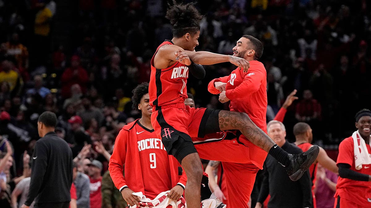 Houston Rockets' Jalen Green (0) celebrates with teammates after making a basket against the Los Angeles Lakers during overtime of an NBA basketball game Wednesday, March 9, 2022, in Houston. The Rockets won 139-130 in overtime.