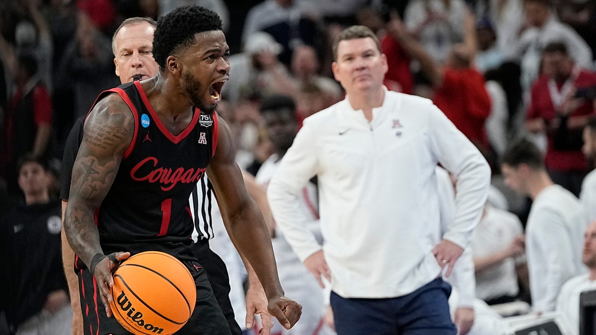 Houston guard Jamal Shead celebrates after scoring as Arizona head coach Tommy Lloyd looks on during the second half of a college basketball game in the Sweet 16 round of the NCAA tournament on Thursday, March 24, 2022, in San Antonio.