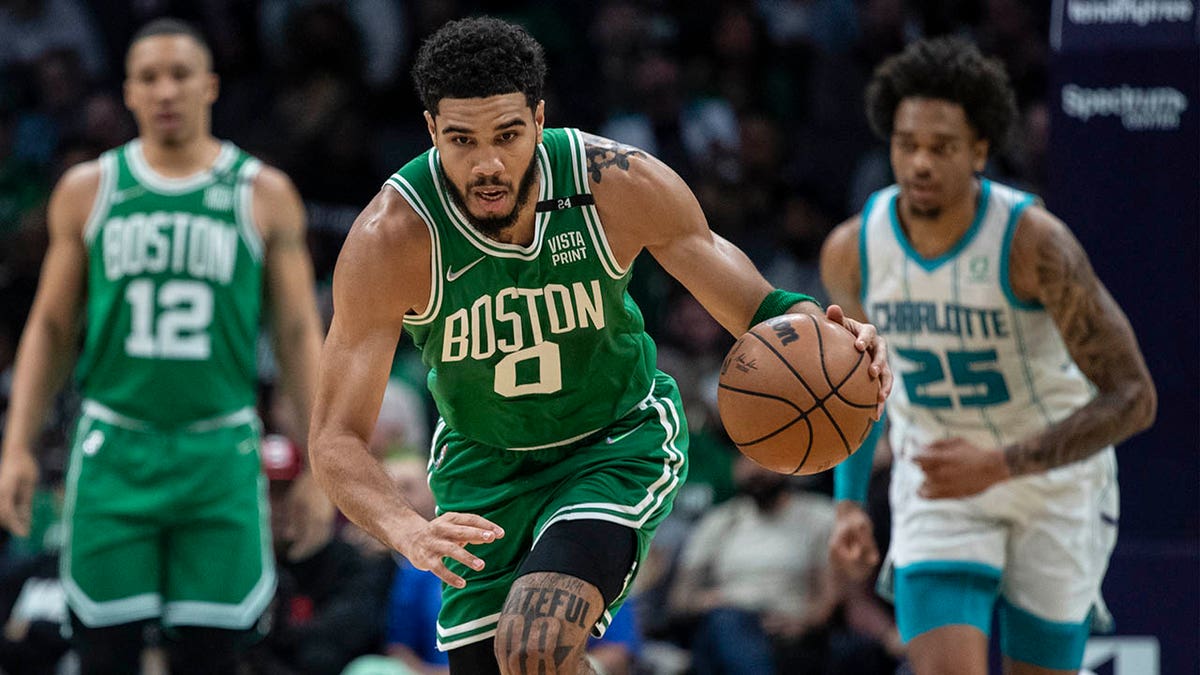 Boston Celtics forward Jayson Tatum (0) leads a fast break during the first half of the team's NBA basketball game against the Charlotte Hornets, Wednesday, March 9, 2022, in Charlotte, N.C.