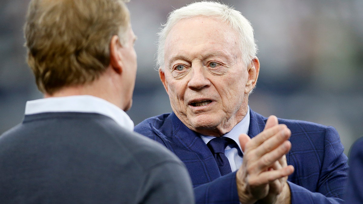 Dallas Cowboys owner Jerry Jones talks (R) with NFL Commissioner Roger Goodell (L) before the game against the San Francisco 49ers in a NFC Wild Card playoff football game at AT&amp;T Stadium on Jan 16, 2022.