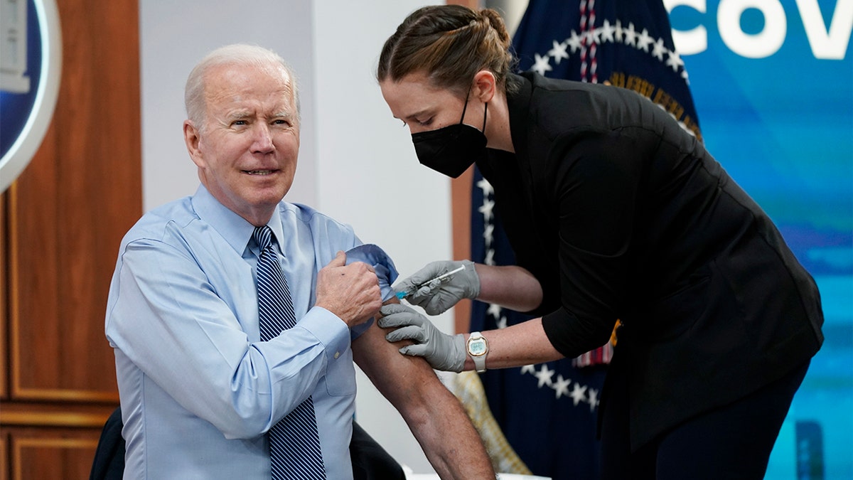 President Biden receives his second COVID-19 booster shot in the South Court Auditorium on the White House campus, Wednesday, March 30, 2022, in Washington. (AP Photo/Patrick Semansky)