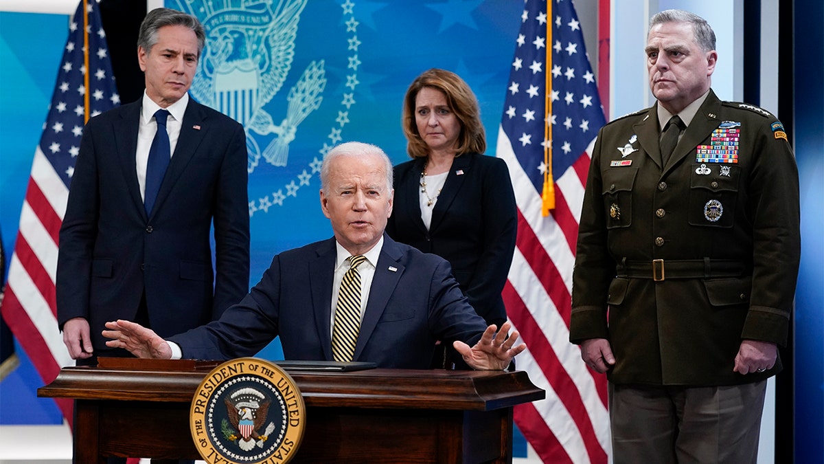 President Biden speaks after signing a delegation of authority in the South Court Auditorium on the White House campus in Washington, Wednesday, March 16, 2022. From left, Secretary of State Antony Blinken, Biden, Deputy Secretary of Defense Kathleen Hicks and Chairman of the Joint Chiefs of Staff General Mark Milley. (AP Photo/Patrick Semansky)