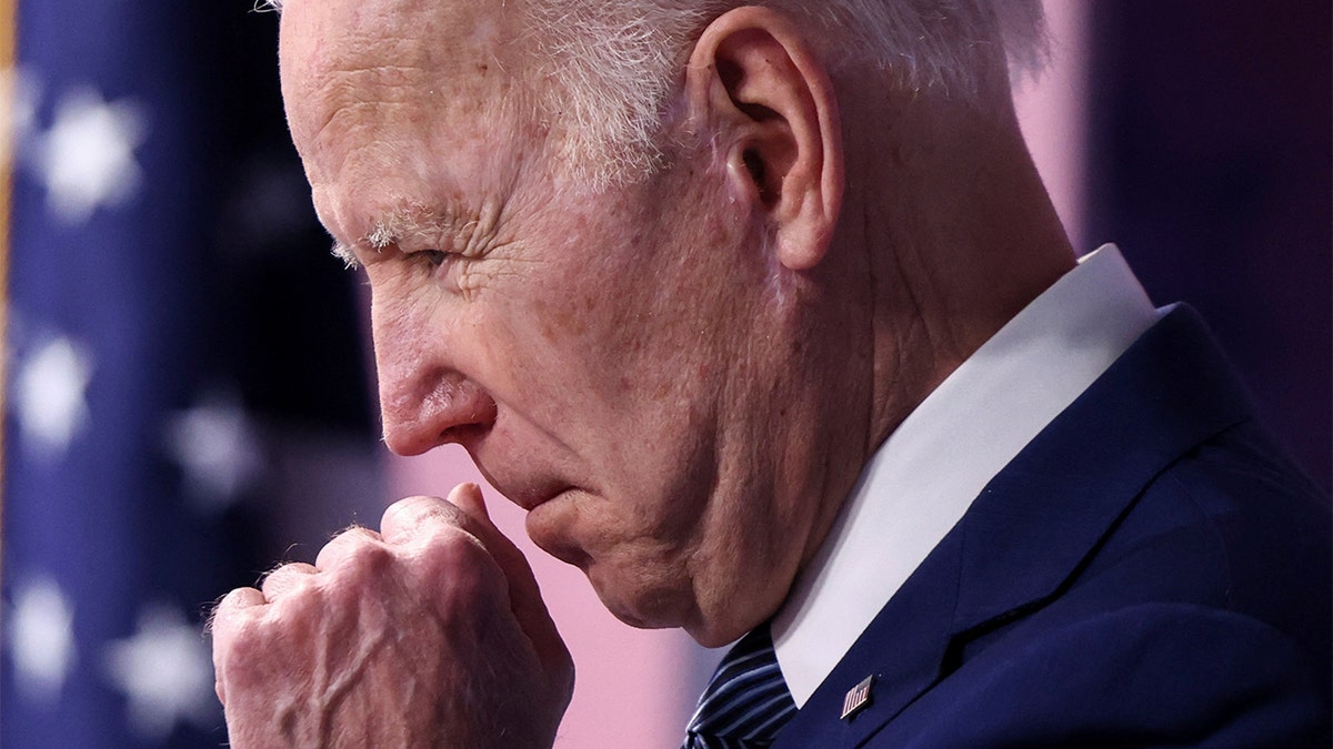 President Biden clears his throat as he announces new steps requiring government to buy more made-in-America goods during remarks in the Eisenhower Executive Office Building's South Court Auditorium at the White House in Washington, March 4, 2022. REUTERS/Evelyn Hockstein