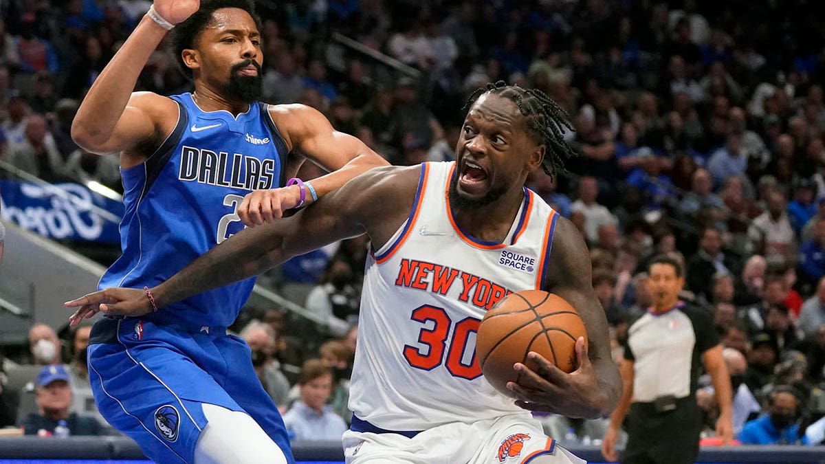 New York Knicks forward Julius Randle (30) drives against Dallas Mavericks guard Spencer Dinwiddie (26) during the second half of an NBA basketball game in Dallas, Wednesday, March 9, 2022. The Knicks won 107-77.