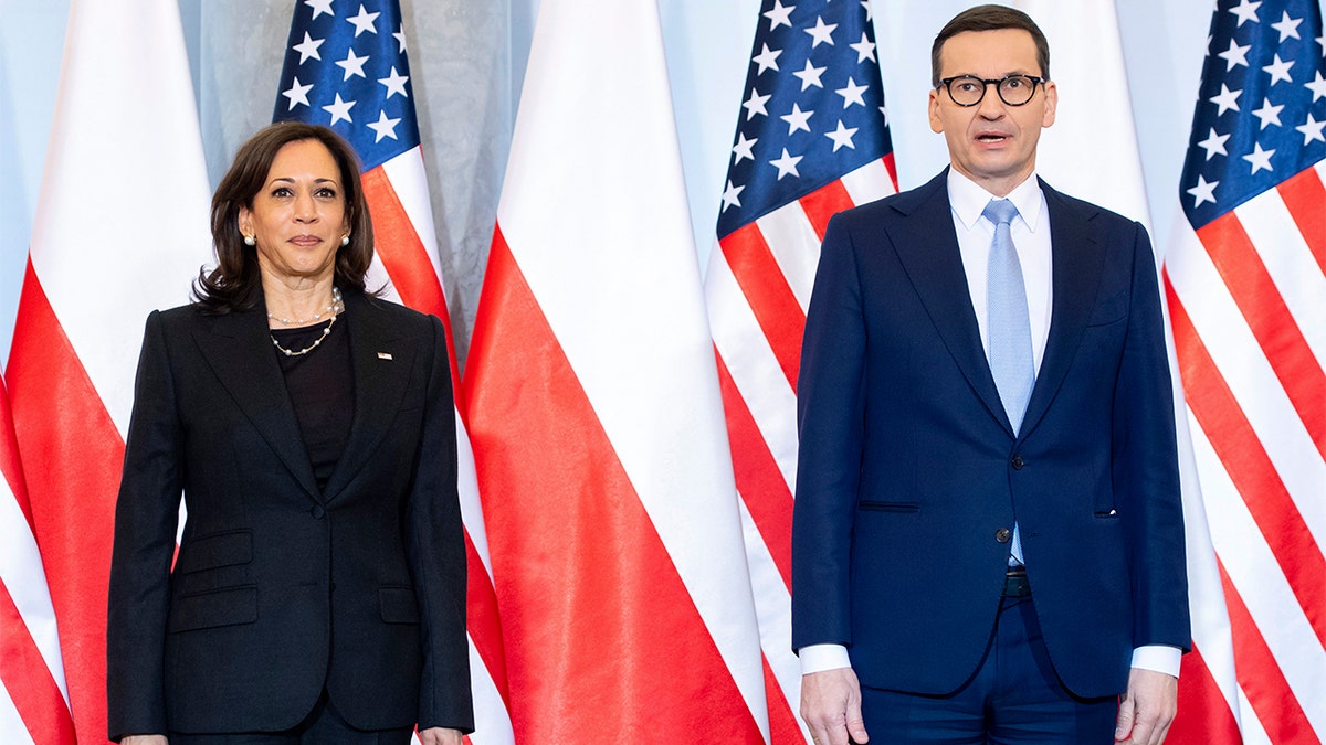 Poland's Prime Minister Mateusz Morawiecki, right, and US Vice President Kamala Harris pose for a photo as she arrives for a meeting, in Warsaw, Poland, Thursday, March 10, 2022. (Saul Loeb/Pool Photo via AP)