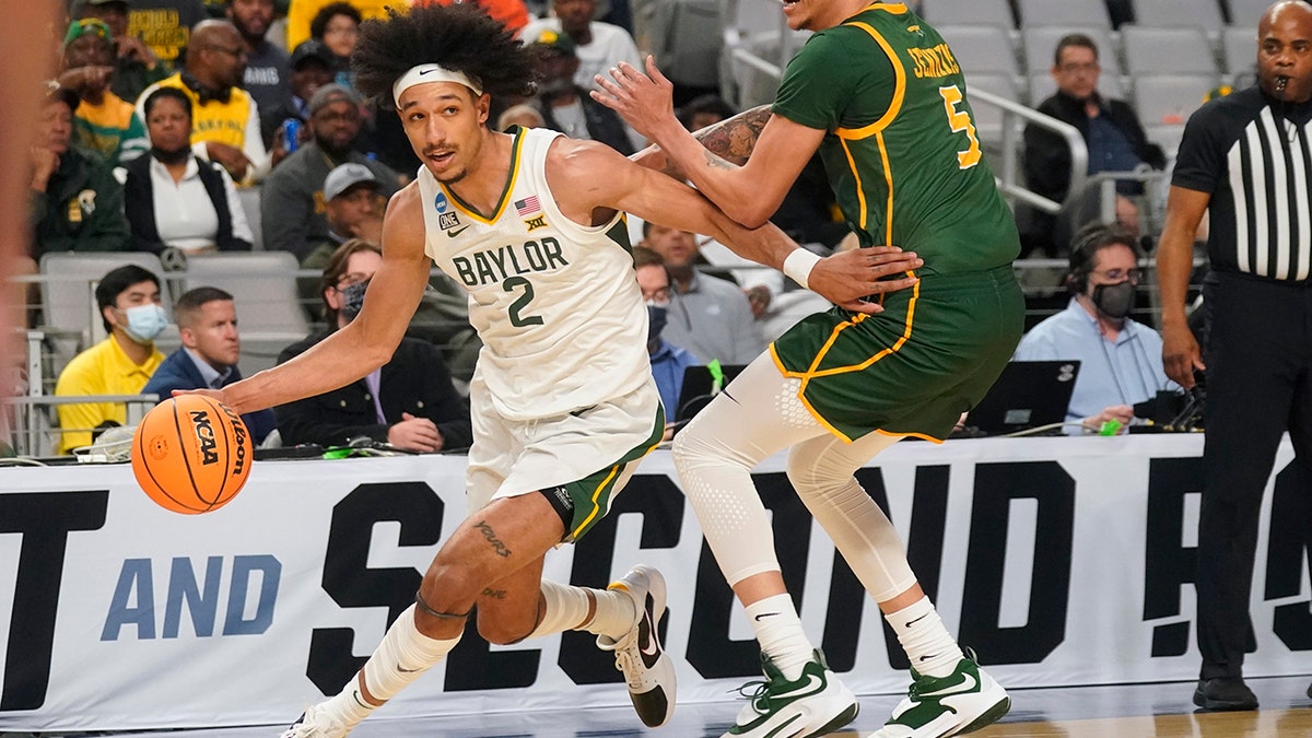 Baylor guard Kendall Brown (2) drives against Norfolk State guard Tyrese Jenkins (5) during the first half of a college basketball game in the first round of the NCAA tournament in Fort Worth, Texas, Thursday, March 17, 2022.