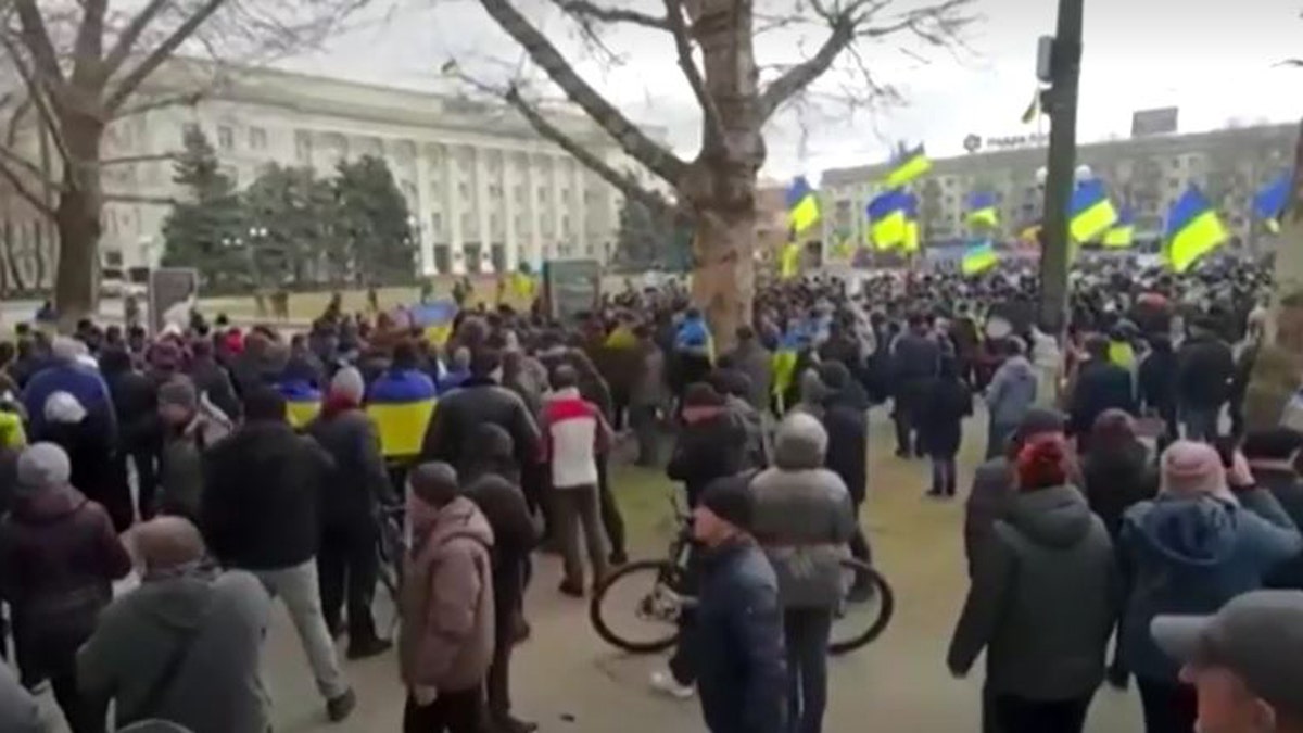 Ukrainians in Kherson rally against Russian forces after city's seizure.