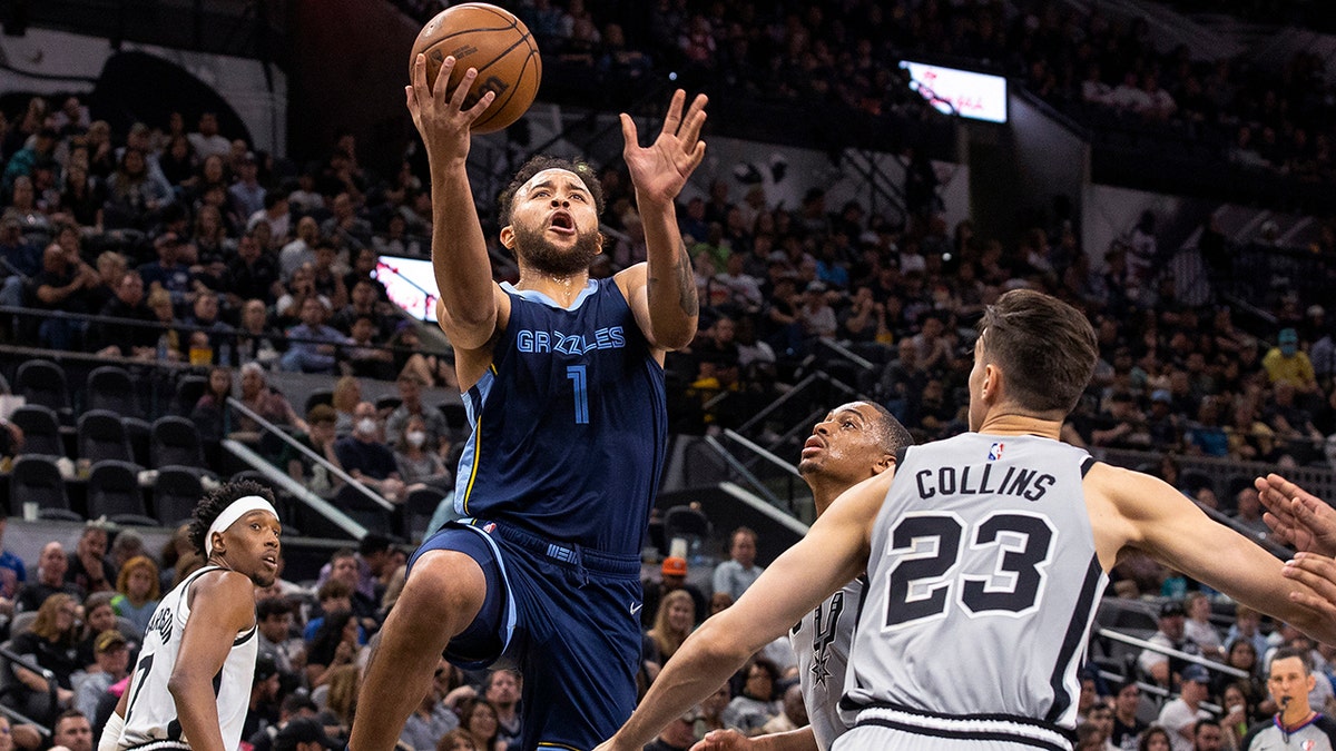 Memphis Grizzlies forward Kyle Anderson (1) drives to the basket against San Antonio Spurs forward Zach Collins (23) during the second half of an NBA basketball game Wednesday, March 30, 2022, in San Antonio.
