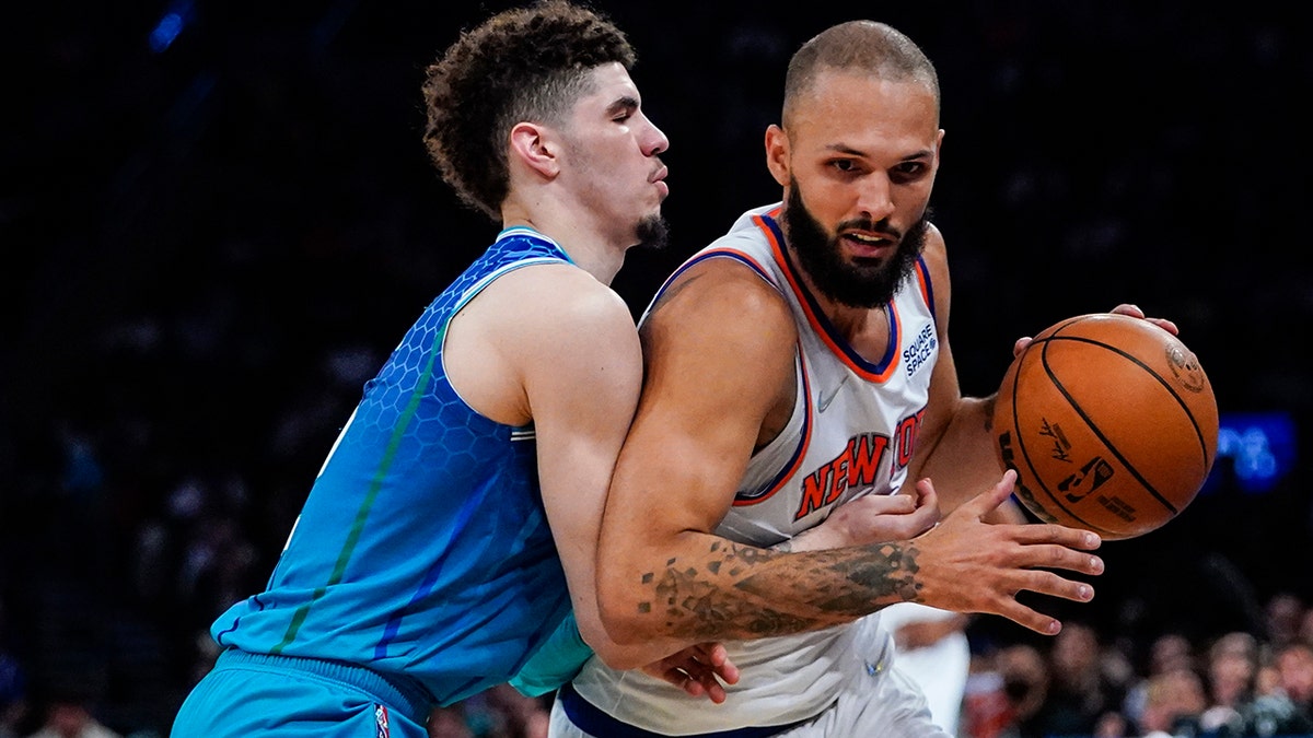 Charlotte Hornets' LaMelo Ball, left, defends against New York Knicks' Evan Fournier during the second half of an NBA basketball game Wednesday, March 30, 2022, in New York.