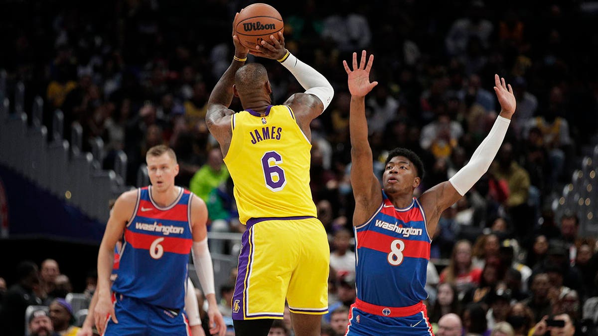 LeBron James shoots while Rui Hachimura defends