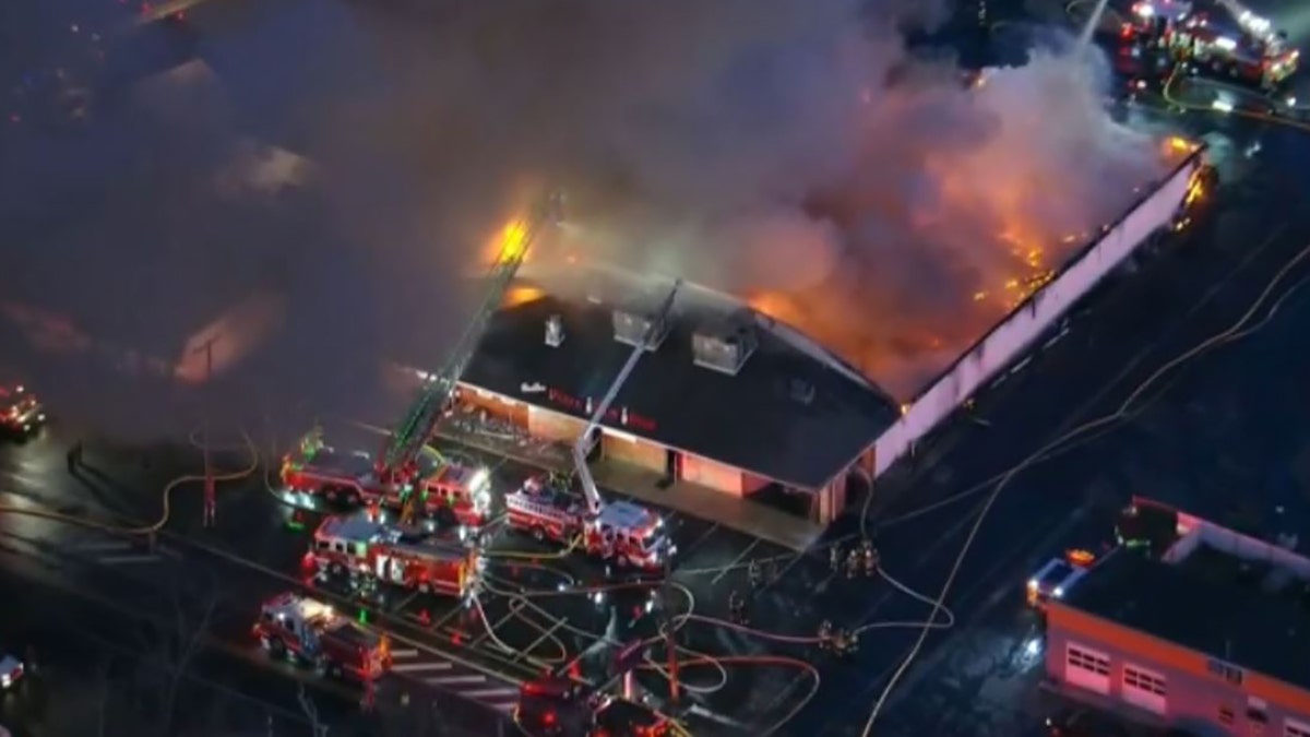 A massive fire tore through a Philadelphia-area bowling alley early Wednesday and destroyed the entire structure.