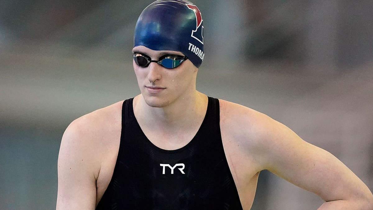 Lia Thomas prepares for race wearing swimming cap and goggles