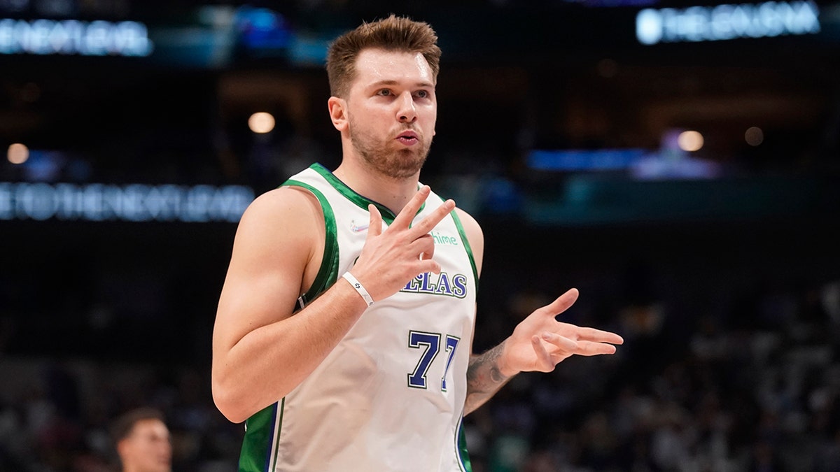Dallas Mavericks guard Luka Doncic (77) blows on his fingers after scoring a three pointer during the first quarter of an NBA basketball game against the Los Angeles Lakers in Dallas, Tuesday, March 29, 2022.
