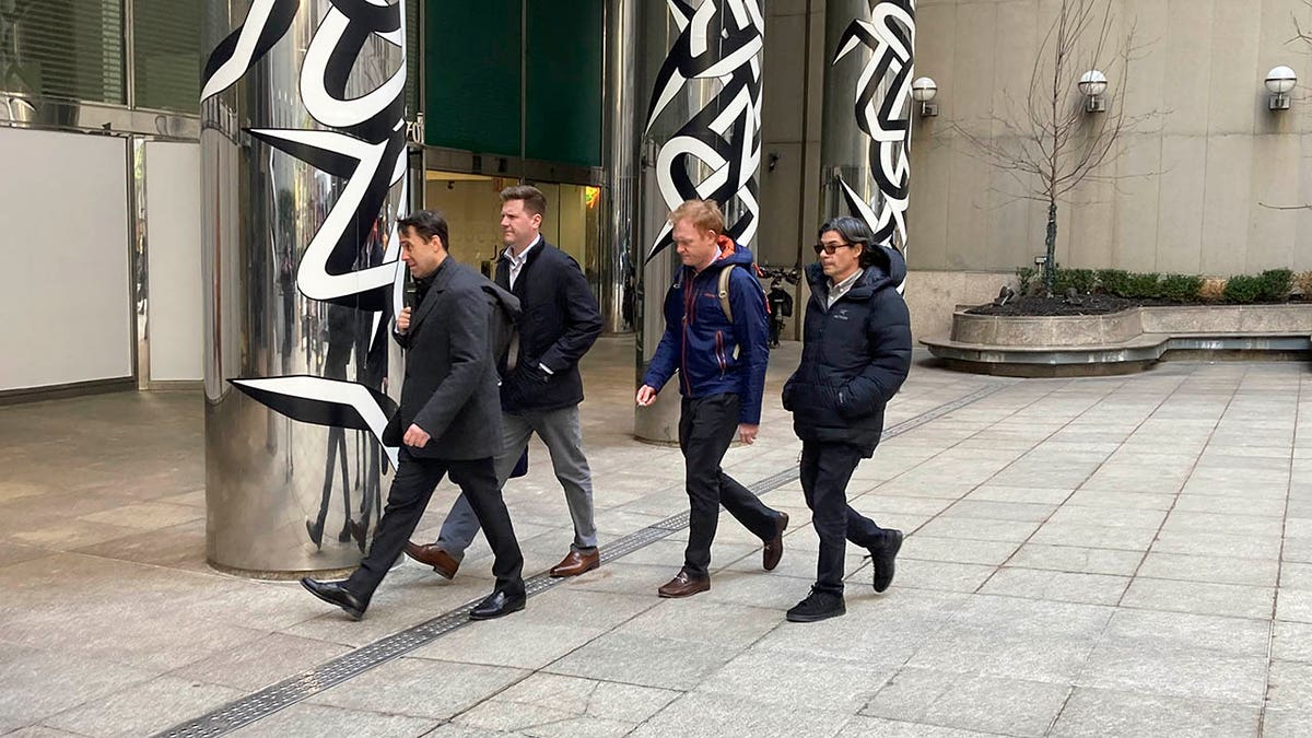 Major League Baseball Deputy Commissioner Dan Halem, left, Senior Vice President Patrick Houlihan, second from left, Executive Vice President Morgan Sword, second from right, and spokesman Glen Caplin arrive at the Major League Baseball Players Association in New York for labor negotiations, Tuesday March 8, 2022.