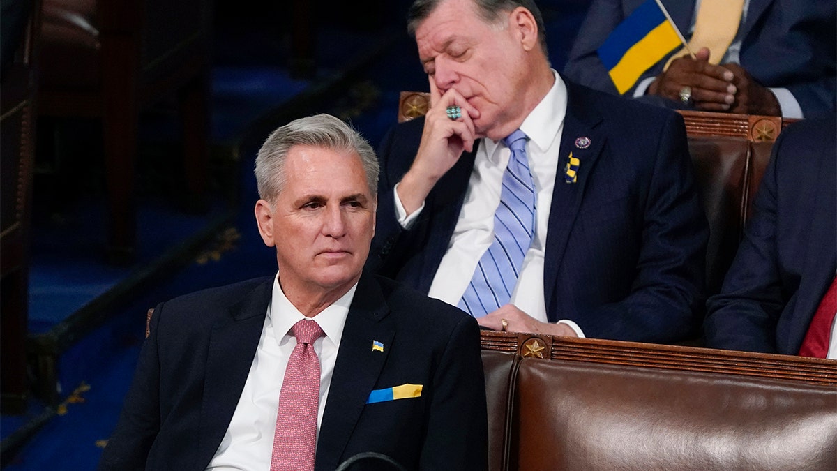 House Minority Leader Kevin McCarthy of Calif., listens as Rep. Tom Cole, R-Okla., closes his eyes as President Joe Biden delivers his first State of the Union address to a joint session of Congress, at the Capitol in Washington, Tuesday, March 1, 2022.