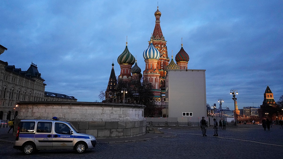 FILE - A police car is parked in Red Square, with St. Basil's Cathedral in the background, in Moscow, Russia, March 4, 2022. (AP Photo, File)