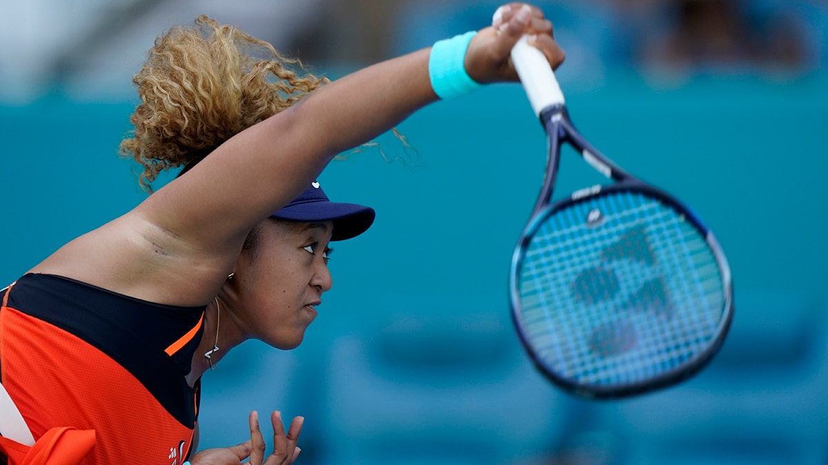 Naomi Osaka, of Japan, serves to Alison Riske during the Miami Open tennis tournament, Monday, March 28, 2022, in Miami Gardens, Fla.