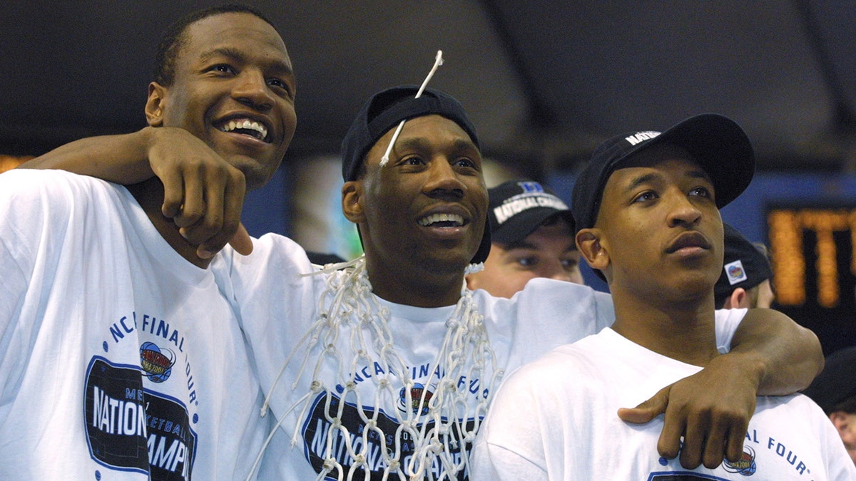 Casey Sanders, Nate James and Chris Duhon celebrate after defeating Arizona at the Metrodome in Minneapolis, Minnesota, on April 2, 2001.